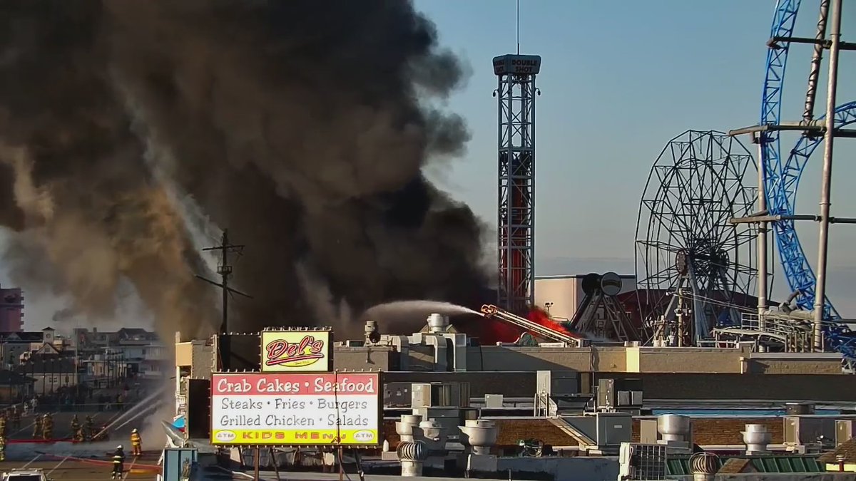 Fire crews continue to battle a four-alarm fire near Playland's Castaway Cove Amusement Pier