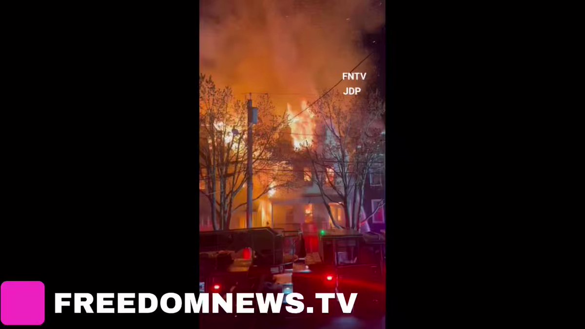 Neighborhood residents hose down their homes in a last ditch effort to save there houses from flying embers as firefighters battled heavy 3 alarm fire on Janet Street in Weehawken, New Jersey