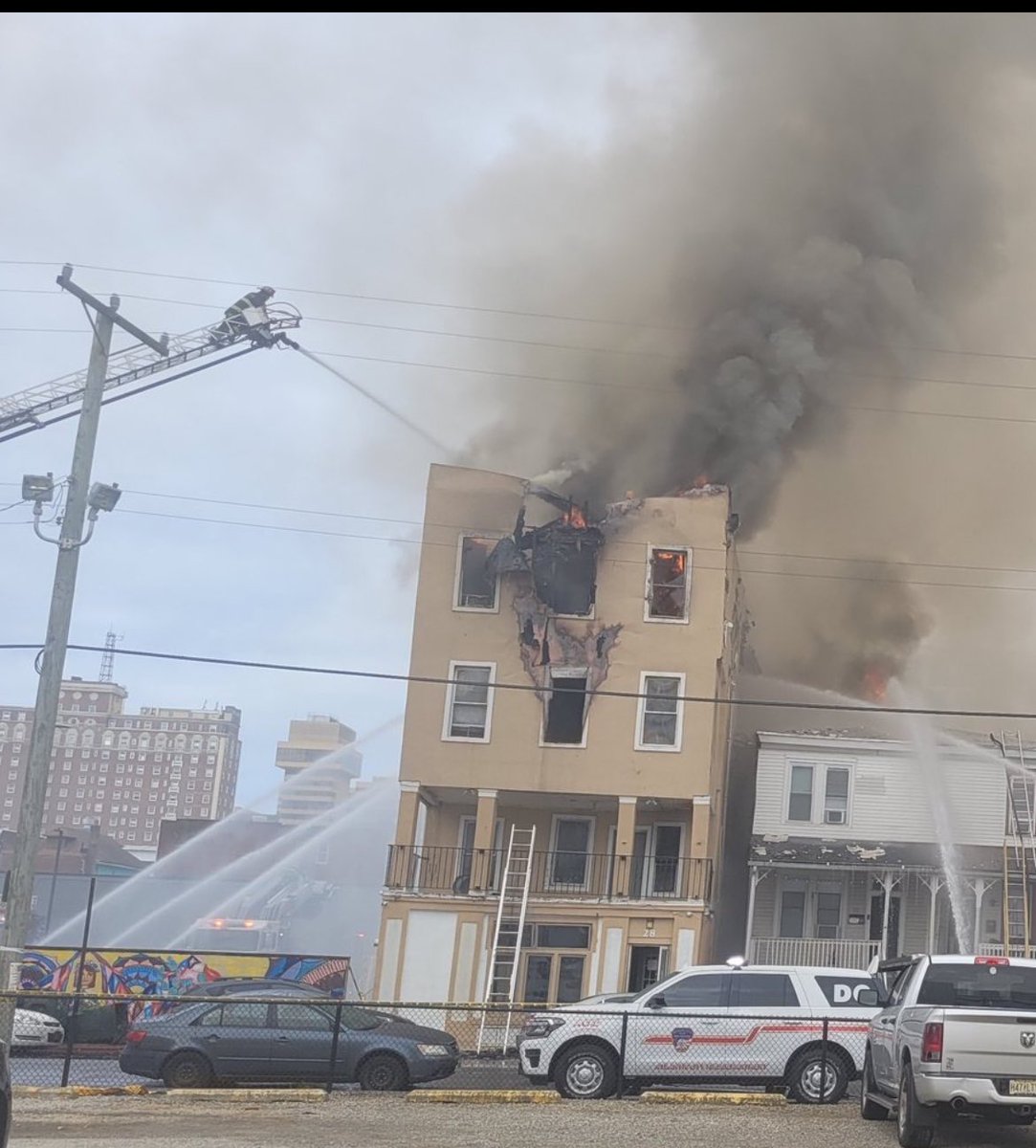 Atlantic City firefighters continue work at scene of 5-alarm fire in a rooming house on the block behind  Boardwalk Hall, at 28 South Georgia Avenue