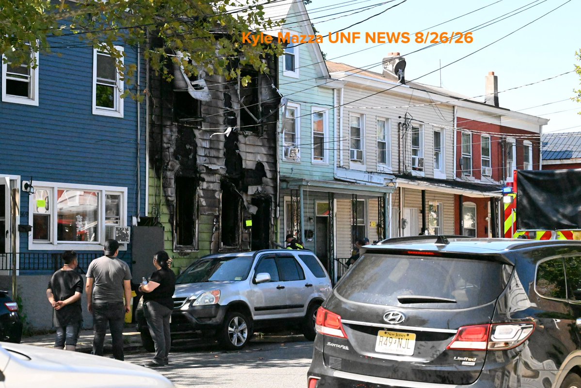 Trenton Fire Department personnel and investigators work the scene where two children died after a three-alarm house fire on the 300 block of Hewitt Street in Trenton, New Jersey