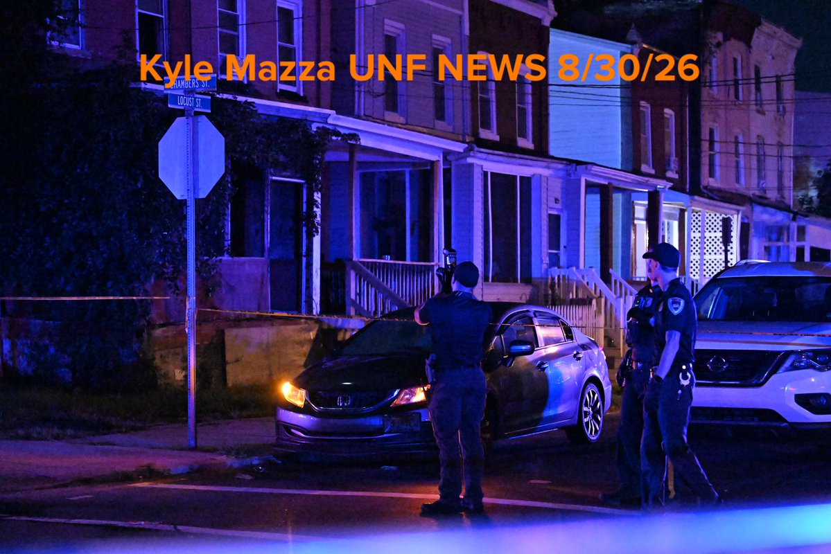 Trenton Police officers work the scene where multiple people were shot in the area of Locust Street in Trenton, New Jersey, United States on August 30, 2026. Sunday morning after midnight the shooting reportedly transpired. Police set up a crime scene cordon blocking off roads
