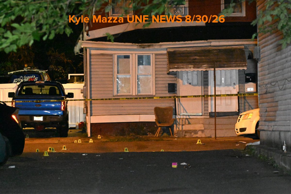Evidence markers are seen on the ground where 2 people were killed and 9 people were injured in a mass shooting on Locust Street in Trenton, New Jersey, United States on Sunday 