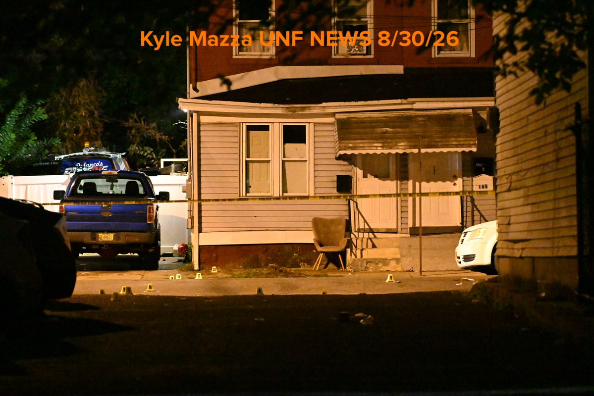 Evidence markers are seen on the ground where 2 people were killed and 9 people were injured in a mass shooting on Locust Street in Trenton, New Jersey, United States on Sunday 