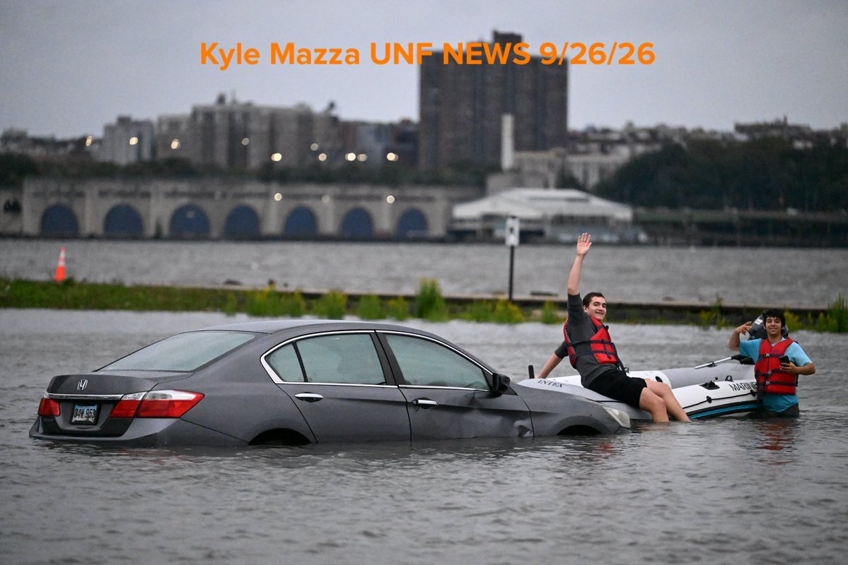 Vehicles are seen submerged in floodwaters in a parking lot along the Hudson River during a nor'easter storm in Edgewater, New Jersey 