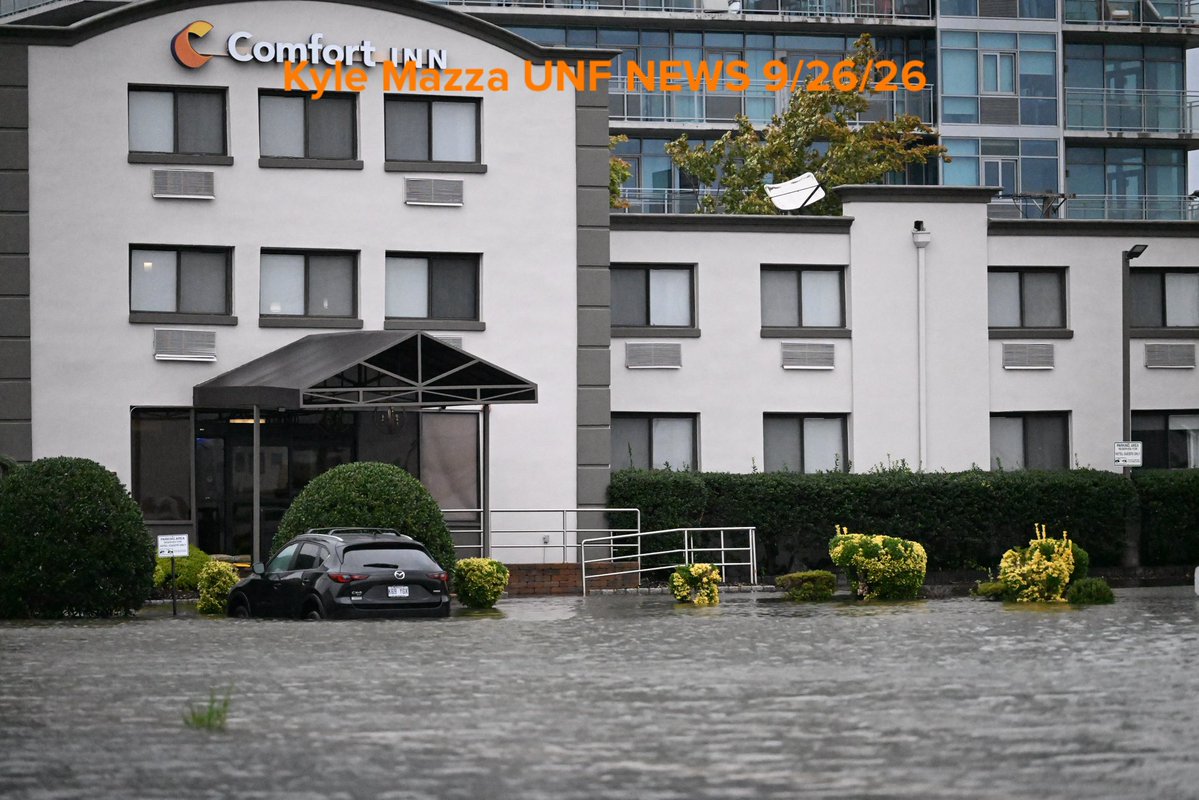 Vehicles are seen submerged in floodwaters in a parking lot along the Hudson River during a nor'easter storm in Edgewater, New Jersey 