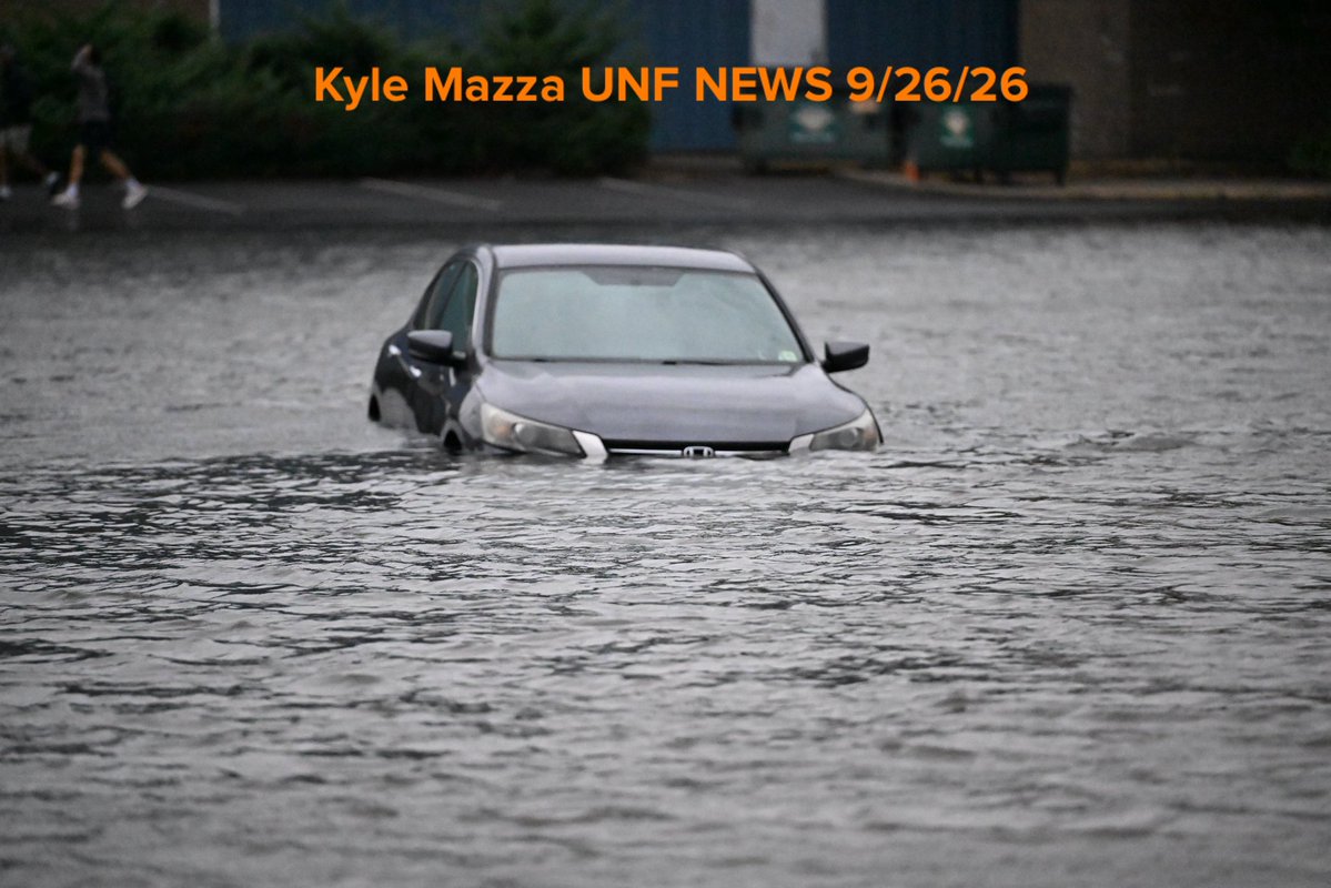 Vehicles are seen submerged in floodwaters in a parking lot along the Hudson River during a nor'easter storm in Edgewater, New Jersey 